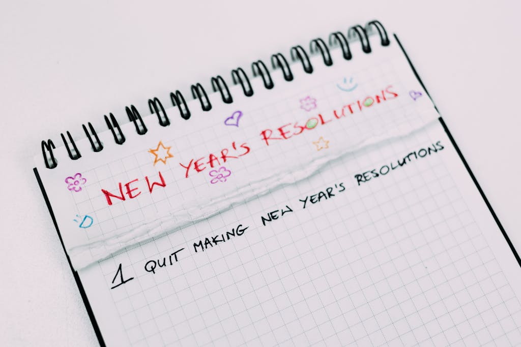 A notebook page with handwritten New Year's resolutions in colorful text.