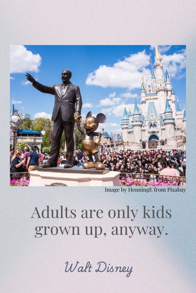 A statue of Walt Disney holding hands with Mickey Mouse stands outside Cinderella's Castle at Magic Kingdom. A Walt Disney quote reads "Adules are only kids grown up, anyway." 