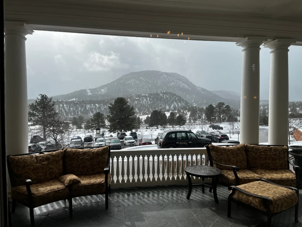 A view of a snow-covered mountain from a porch