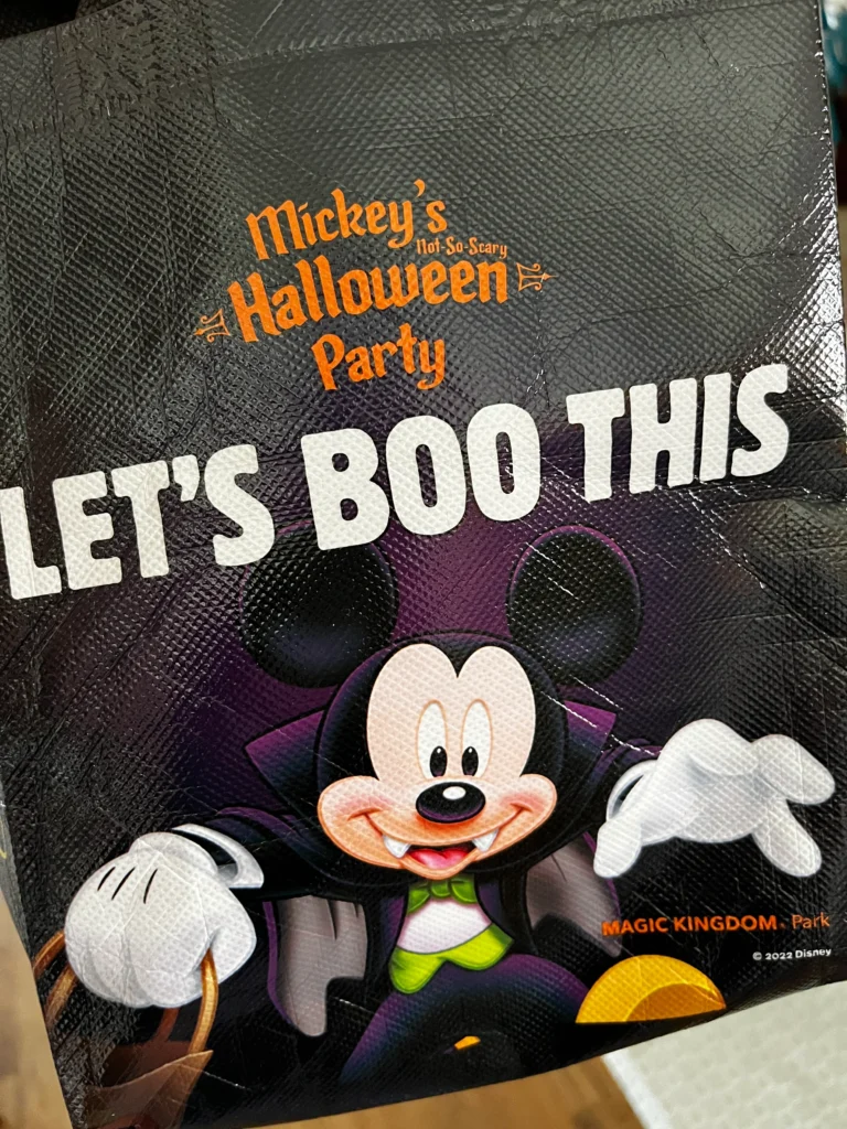 Mickey Mouse dressed as Count Dracula decorates a small candy bag for the 2022 Mickey's Not So Scary Halloween Party.