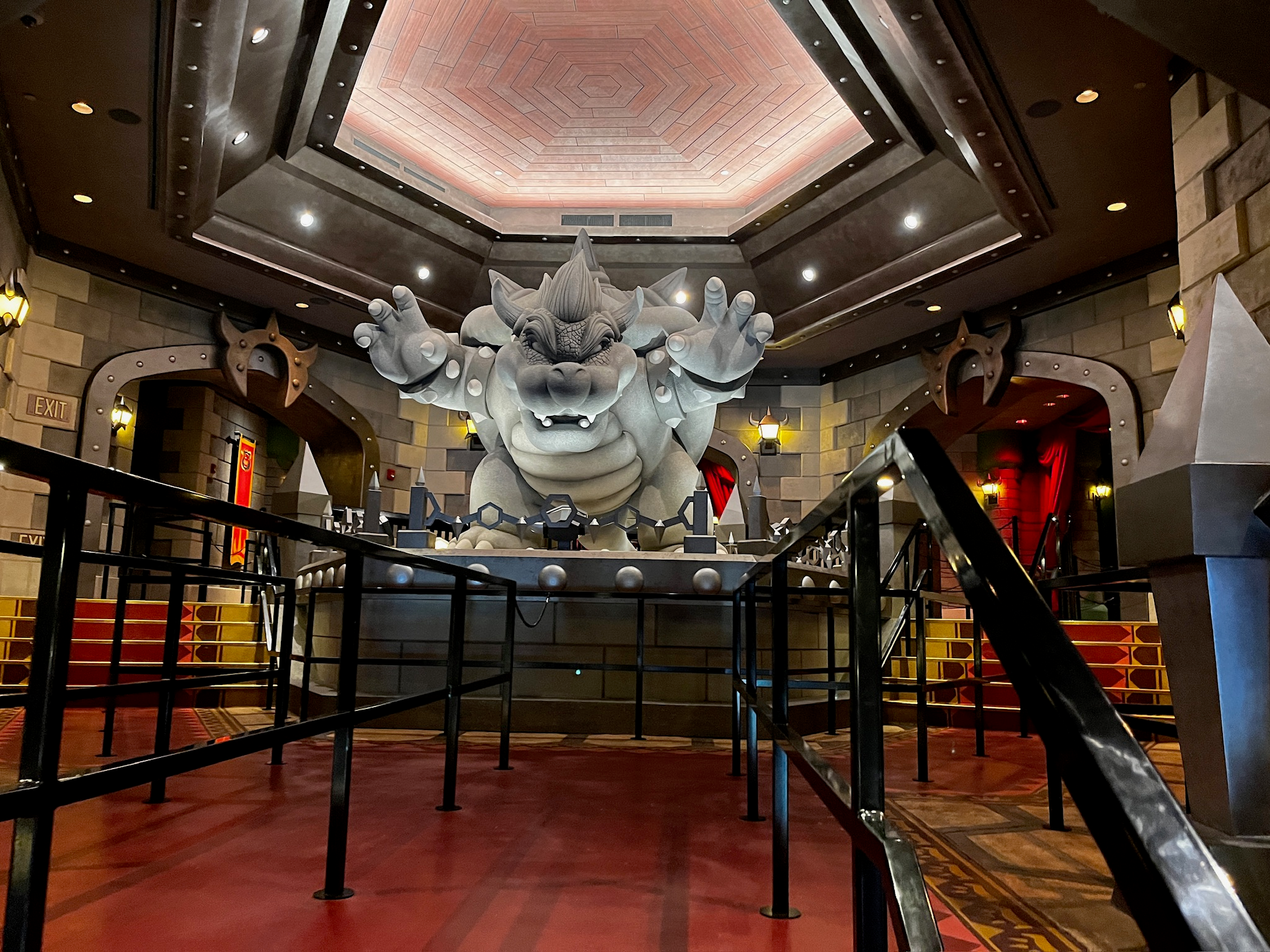 A statue of Bowser stands inside the entry to the ride at Epic Universe.