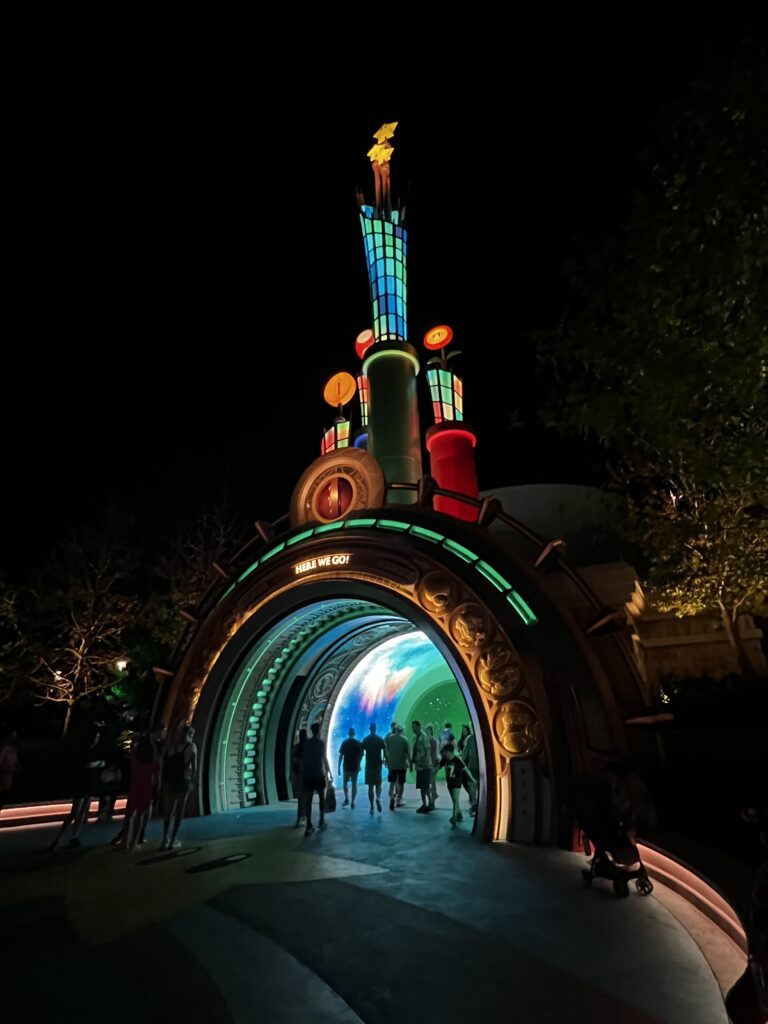 The portal at Super Nintendo World lit up at night.